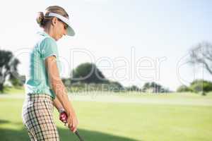 Focused woman playing golf