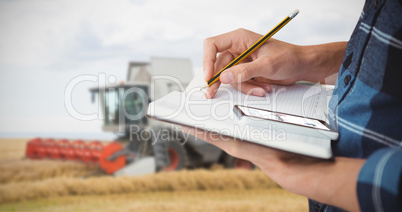 Composite image of cropped image of farmer writing with pencil o