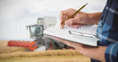 Composite image of cropped image of farmer writing with pencil o