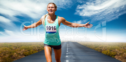 Composite image of sportswoman finishing her run