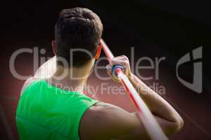 Composite image of rear view of sportsman practising javelin thr