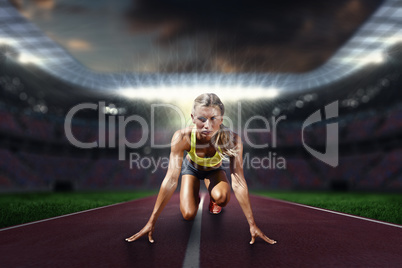 Composite image of sportswoman in the starting block