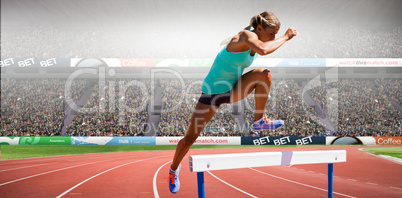 Composite image of athlete woman jumping a hurdle