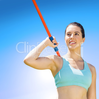 Composite image of woman sporty posing with her javelin