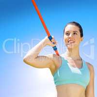 Composite image of woman sporty posing with her javelin