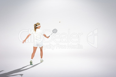 Composite image of badminton player playing badminton