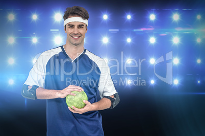 Composite image of sportsman posing with ball on white backgroun