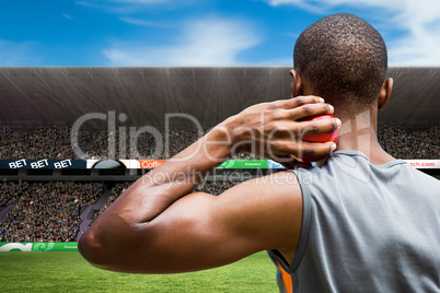 Composite image of rear view of sportsman practising shot put