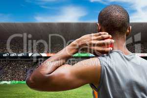 Composite image of rear view of sportsman practising shot put