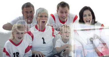 Composite image of excited family watching a football match in t