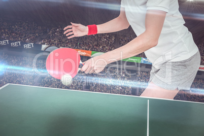 Composite image of female athlete playing ping pong