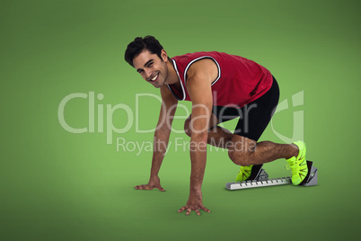 Composite image of male athlete is smiling in the starting block