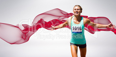 Composite image of sportswoman finishing her run