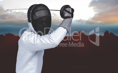 Composite image of man wearing fencing suit practicing with swor