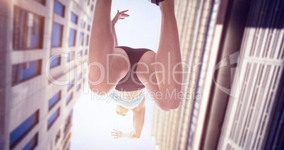 Composite image of low angle female athlete jumping