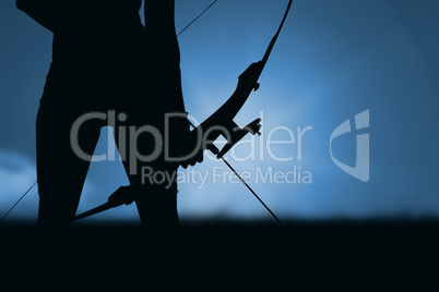 Composite image of focus on sportswoman holding an arch
