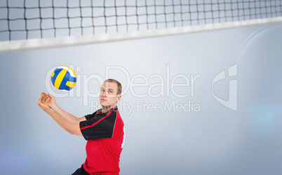 Composite image of sportsman posing while playing volleyball