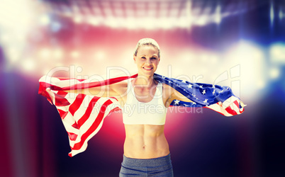 Composite image of portrait of smiling sportswoman posing with a
