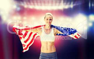 Composite image of portrait of smiling sportswoman posing with a