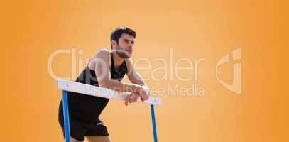 Athletic man pressed on a hurdle posing
