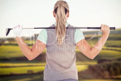 Composite image of pretty blonde playing golf rear view