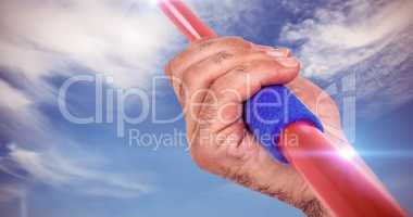 Composite image of close-up of hand holding javelin