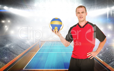 Composite image of sportsman holding a volleyball