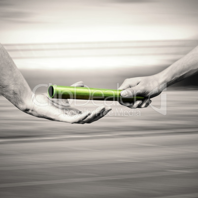 Man passing the baton to partner on track