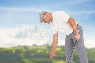 Composite image of golf player picking up golf ball
