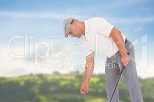 Composite image of golf player picking up golf ball