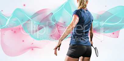 Composite image of sportswoman is playing badminton