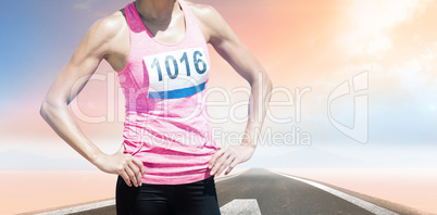 Composite image of sportswoman chest is posing with hands on hip