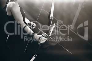 Composite image of sportswoman practicing archery