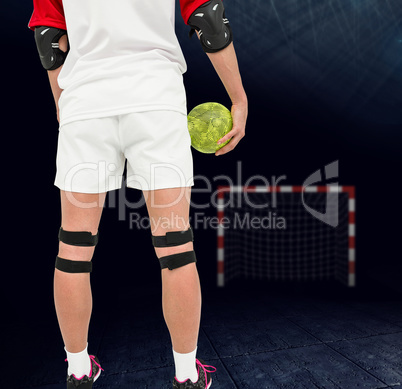 Composite image of sportswoman holding a ball