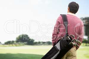 Man carrying golf equipment