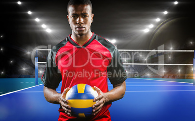 Composite image of sportsman holding a volleyball