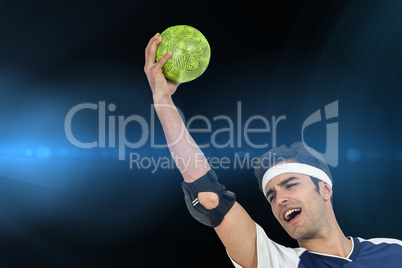 Composite image of sportsman holding a ball on white background