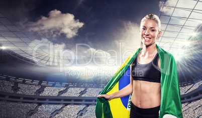 Composite image of athlete with brazilian flag wrapped around hi