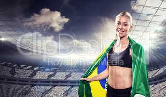 Composite image of athlete with brazilian flag wrapped around hi