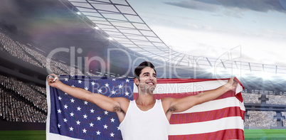 Composite image of athlete posing with american flag after victo