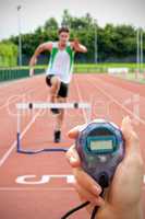 Composite image of close up of woman is holding a stopwatch on a