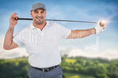 Composite image of portrait of golf player holding a golf club w