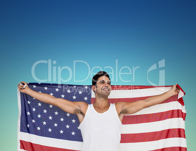 Athlete posing with american flag after victory against dark blu
