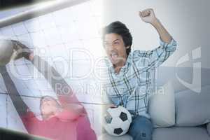 Composite image of man cheering soccer team during a match on te