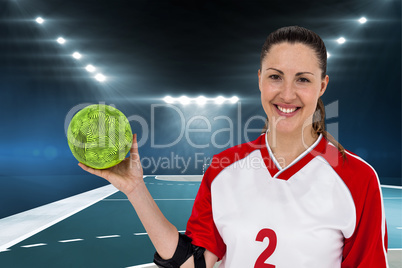 Composite image of sportswoman posing with ball