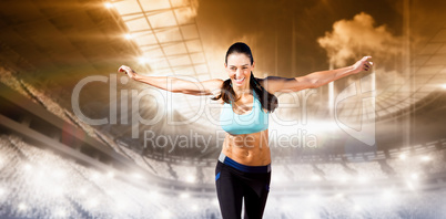 Composite image of happy sportswoman is raising arms