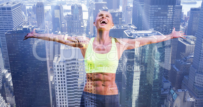 Composite image of fit woman celebrating victory with arms stret