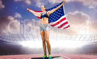 Composite image of an athletic woman holding american flag and m