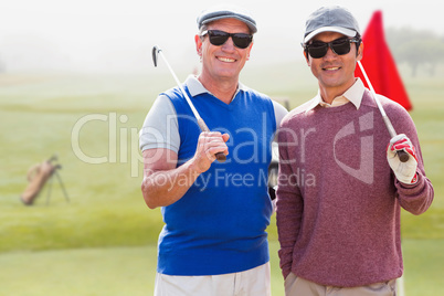 Composite image of men holding golf club