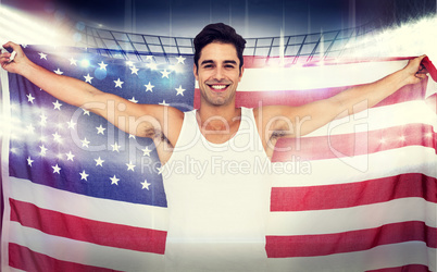 Composite image of athlete posing with american flag after victo